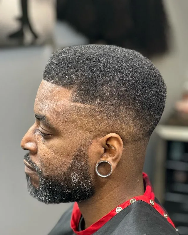 A mid fade with a boxy textured top blending to skin, by Clifton Al-Hakeem in Owings Mills