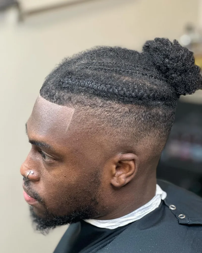 High fade under braids by Clifton Bey at Al-Hakeem's Tonsorial