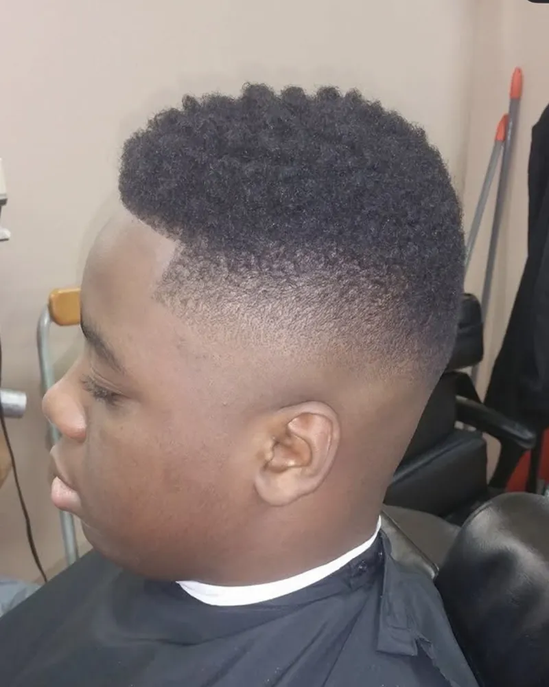 High-top fade on a young client by Clifton Bey at Al-Hakeem's Tonsorial